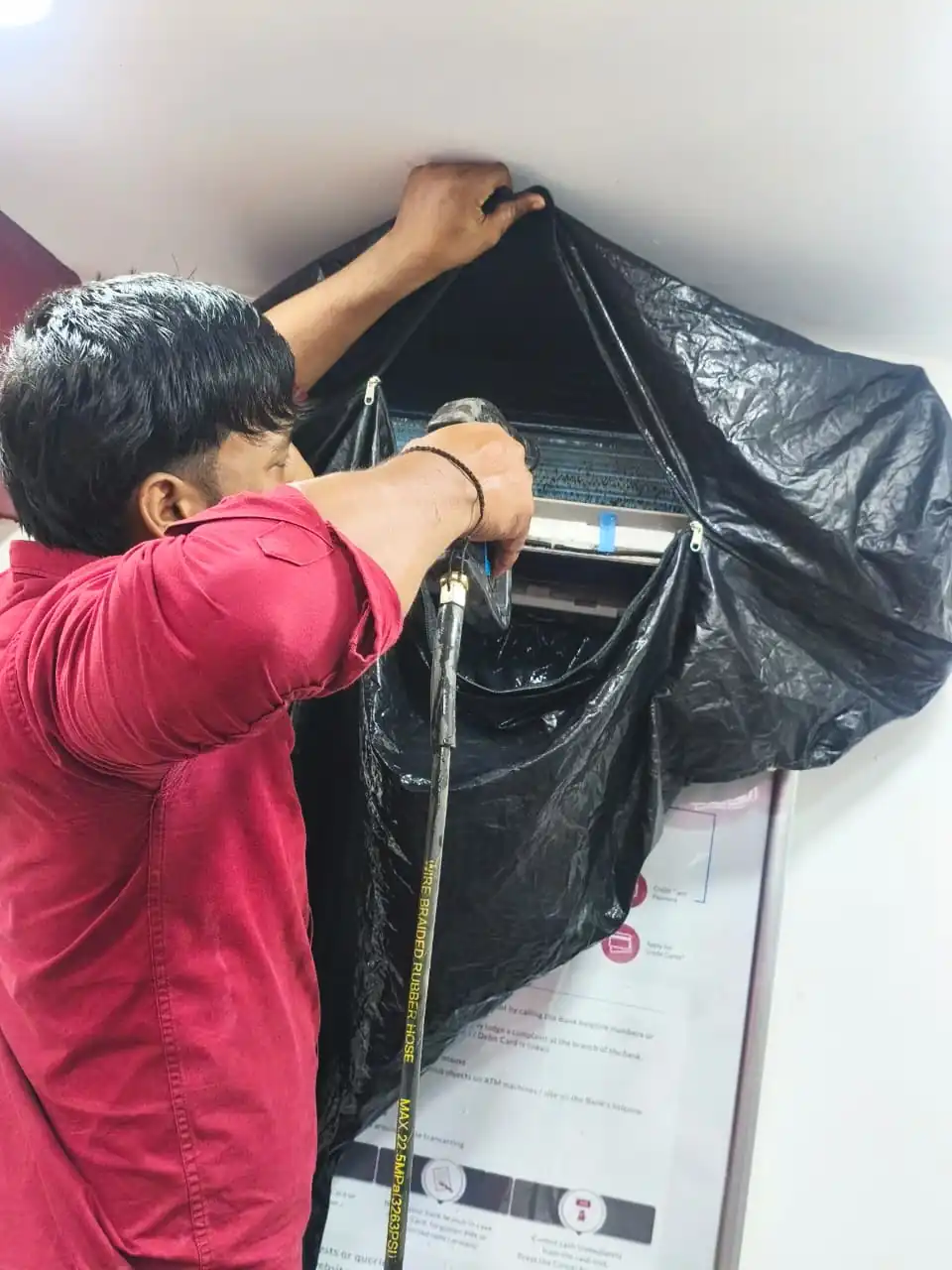 Technician servicing a split AC indoor unit